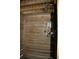 Enclosed outdoor shower featuring wood paneling, shower head, and convenient shelving at 3904 Birchwood St., North Myrtle Beach, SC 29582