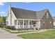 Inviting home exterior with a covered porch, brick accents, manicured landscaping, and a welcoming facade at 441 Garden Ave., Georgetown, SC 29440