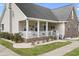 Charming home exterior features a covered front porch, brick accents, and lush landscaping at 441 Garden Ave., Georgetown, SC 29440