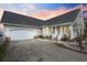 Home exterior featuring an attached garage, well-lit porch, and concrete driveway at 441 Garden Ave., Georgetown, SC 29440