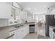 Bright kitchen with white cabinetry, granite countertops, stainless steel appliances, and an eat-in breakfast nook at 441 Garden Ave., Georgetown, SC 29440