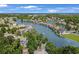 Aerial view showcasing a waterfront community with houses along a canal, mature trees, and fountains at 601 Hillside Dr. N # 2305, North Myrtle Beach, SC 29582