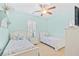 Serene bedroom with twin beds, soothing aqua walls, plantation shutters, and coastal-inspired accents at 601 Hillside Dr. N # 2305, North Myrtle Beach, SC 29582