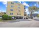 Exterior view of the condo building, showcasing its architecture and green surroundings at 601 Hillside Dr. N # 2305, North Myrtle Beach, SC 29582