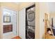 Convenient laundry area with stacked washer and dryer units, complemented by an adjacent bathroom at 601 Hillside Dr. N # 2305, North Myrtle Beach, SC 29582