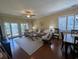 A cozy living room with a sliding glass door leading to a balcony and dining table at 601 Hillside Dr. N # 2305, North Myrtle Beach, SC 29582