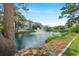 Scenic view of a tranquil pond with a fountain surrounded by lush greenery, perfect for relaxing at 601 Hillside Dr. N # 2305, North Myrtle Beach, SC 29582
