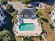 Aerial view of a pool with lounge chairs, hot tub, and surrounding landscaping for relaxation and recreation at 601 Hillside Dr. N # 2305, North Myrtle Beach, SC 29582