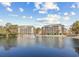 Picturesque view of calm water with fountain, framed by condominiums under a bright sky with fluffy clouds at 601 Hillside Dr. N # 2305, North Myrtle Beach, SC 29582