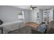 Bedroom with a ceiling fan, light blue walls, grey rug and access to the bathroom at 613 Cypress Dr., Surfside Beach, SC 29575