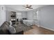 Cozy bedroom featuring a ceiling fan, light blue walls and laminate flooring and a grey sofa at 613 Cypress Dr., Surfside Beach, SC 29575