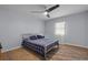 Bedroom with light blue walls, laminate wood flooring and a fan light at 613 Cypress Dr., Surfside Beach, SC 29575