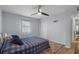 Bedroom features light blue walls, laminate wood flooring and a ceiling fan light at 613 Cypress Dr., Surfside Beach, SC 29575