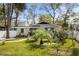 Charming one-story home with a landscaped yard, featuring a brick facade and mature trees at 613 Cypress Dr., Surfside Beach, SC 29575