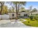 Inviting home with a well-manicured lawn, featuring a paved driveway and a charming brick facade at 613 Cypress Dr., Surfside Beach, SC 29575
