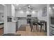Contemporary kitchen with bright white cabinetry, stainless steel appliances, and an eat-in dining space at 613 Cypress Dr., Surfside Beach, SC 29575