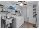 Laundry room with white cabinets, a stainless steel sink, and updated washer and dryer at 613 Cypress Dr., Surfside Beach, SC 29575