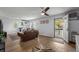 Bright living room featuring wood floors and a comfortable seating arrangement with natural light streaming in at 613 Cypress Dr., Surfside Beach, SC 29575
