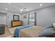 Bright main bedroom offers a large window, wood-look floors, and neutral decor at 613 Cypress Dr., Surfside Beach, SC 29575