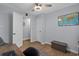 Office space features light blue walls, laminate wood flooring, and a ceiling fan with light at 613 Cypress Dr., Surfside Beach, SC 29575