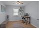 Office features light blue walls, laminate wood flooring, a desk, and a ceiling fan at 613 Cypress Dr., Surfside Beach, SC 29575