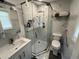 Modern bathroom featuring a glass shower, grab bars, and marble-look tile at 710 62Nd Ave. N, Myrtle Beach, SC 29572