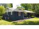 Charming home with manicured lawn, red shutters, and inviting curb appeal at 710 62Nd Ave. N, Myrtle Beach, SC 29572