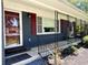 Inviting front porch with red door and shutters, plus a cozy hammock swing at 710 62Nd Ave. N, Myrtle Beach, SC 29572