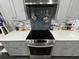 Modern kitchen with stainless steel stove, backsplash, and sleek countertops at 710 62Nd Ave. N, Myrtle Beach, SC 29572