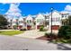 Row of townhomes with well-manicured lawns, featuring brown garage doors and charming landscaping at 72 Landing Rd. # 0, Pawleys Island, SC 29585