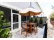 Outdoor patio with an umbrella-covered table and chairs for al fresco dining and entertaining at 72 Landing Rd. # 0, Pawleys Island, SC 29585