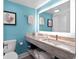 Bright bathroom featuring modern vanity, vibrant blue walls, and well-lit mirror at 7200 N Ocean Blvd. # 438, Myrtle Beach, SC 29577