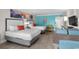 Cozy bedroom featuring two beds, a flat-screen TV, and vibrant artwork at 7200 N Ocean Blvd. # 438, Myrtle Beach, SC 29577