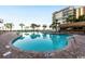 Large outdoor swimming pool with brick surround and seating areas; ideal for relaxation at 7200 N Ocean Blvd. # 438, Myrtle Beach, SC 29577