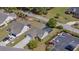 Aerial view showcasing the home, pool area, landscaped yard, and adjacent parking at 90 Carolina Crossing Blvd., Little River, SC 29566