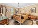 Bedroom boasts a unique bedframe, patterned rug, and bright window at 90 Carolina Crossing Blvd., Little River, SC 29566