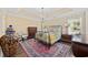 Cozy bedroom with decorative rug, chandelier and patterned wallpaper at 90 Carolina Crossing Blvd., Little River, SC 29566