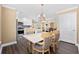 Bright dining area adjacent to kitchen, showcasing elegant chandelier and modern design at 90 Carolina Crossing Blvd., Little River, SC 29566