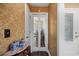 Hallway with patterned wallpaper leading to glass french doors and a front door at 90 Carolina Crossing Blvd., Little River, SC 29566