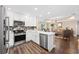Open kitchen with stainless appliances and white cabinetry, seamlessly connected to the living area at 90 Carolina Crossing Blvd., Little River, SC 29566