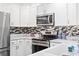 Modern kitchen features stainless steel appliances, white cabinets, and elegant countertops at 90 Carolina Crossing Blvd., Little River, SC 29566