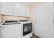 Laundry room with white cabinets and modern washer and dryer units at 90 Carolina Crossing Blvd., Little River, SC 29566