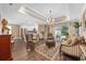 Elegant living room featuring an open layout, chandelier lighting, and access to outdoor area at 90 Carolina Crossing Blvd., Little River, SC 29566