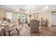 Elegant living room featuring an open layout, chandelier lighting, and access to outdoor area at 90 Carolina Crossing Blvd., Little River, SC 29566