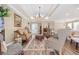 Elegant living room featuring an open layout, chandelier lighting, and stylish seating at 90 Carolina Crossing Blvd., Little River, SC 29566