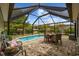 The screened-in pool area includes a dining table and comfortable seating at 90 Carolina Crossing Blvd., Little River, SC 29566