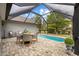 The screened-in pool area includes a dining table and a view of the backyard at 90 Carolina Crossing Blvd., Little River, SC 29566