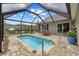 The screened-in pool features a ladder and a view of the backyard at 90 Carolina Crossing Blvd., Little River, SC 29566