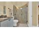 Bathroom with large shower, light-colored tile, granite countertop vanity, and a decorative towel rack at 9243 Marina Pkwy., Myrtle Beach, SC 29572