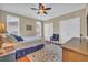 Well-lit bedroom with hardwood flooring, ceiling fan, and a comfortable bed, complemented by closet space at 9243 Marina Pkwy., Myrtle Beach, SC 29572